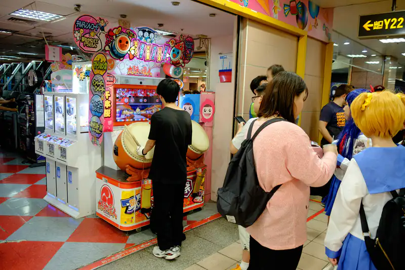 Young people playing colourful arcade games in a game centre