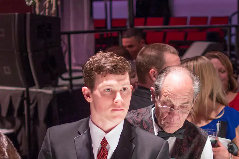 Players in suits gathered around a casino dice table
